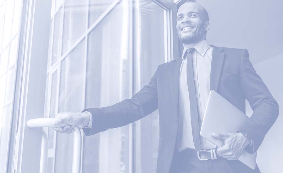 A confident businessman walking out of his office