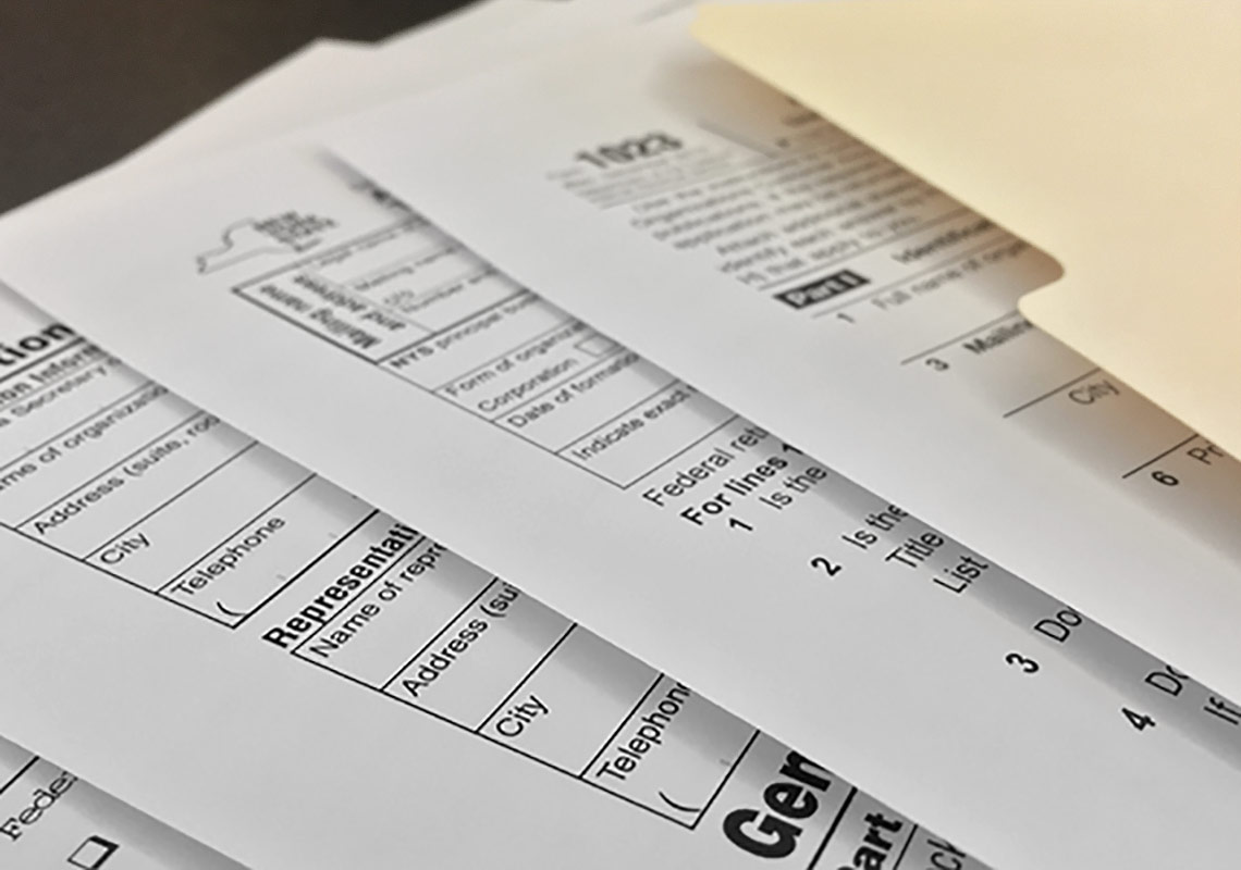 A folder of various tax registration forms